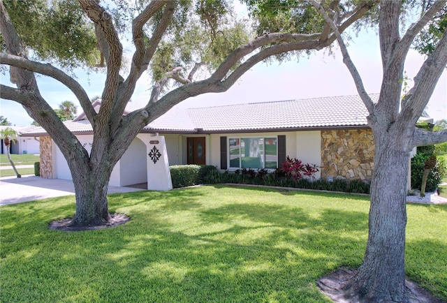 11141 Carla Dr, Largo, FL 33774 - ranch-style home featuring a tile roof, a garage, stucco siding, and a front yard