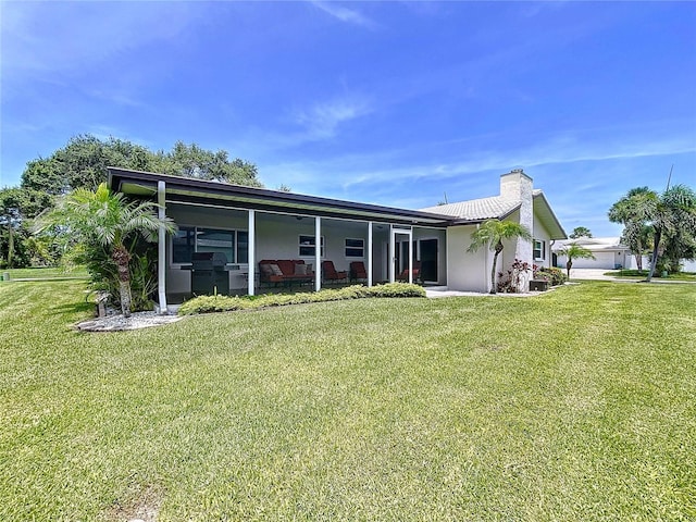 11141 Carla Dr, Largo, FL 33774 - back of property featuring a yard, a chimney, and stucco siding