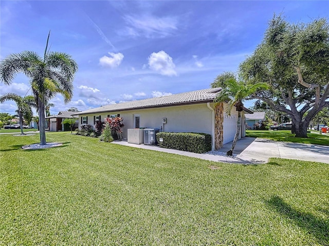 11141 Carla Dr, Largo, FL 33774 - ranch-style house with driveway, stucco siding, an attached garage, a front lawn, and a tiled roof