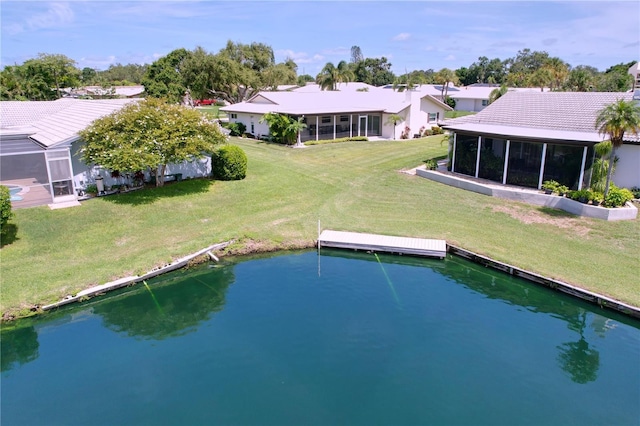 11141 Carla Dr, Largo, FL 33774 - rear view of property with a tile roof, a lawn, and a sunroom