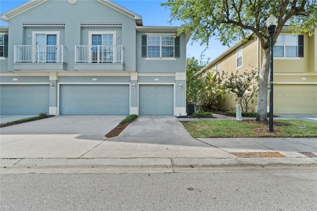 6734 Breezy Palm Dr, Riverview, FL 33578 - view of property featuring an attached garage, stucco siding, driveway, and a balcony