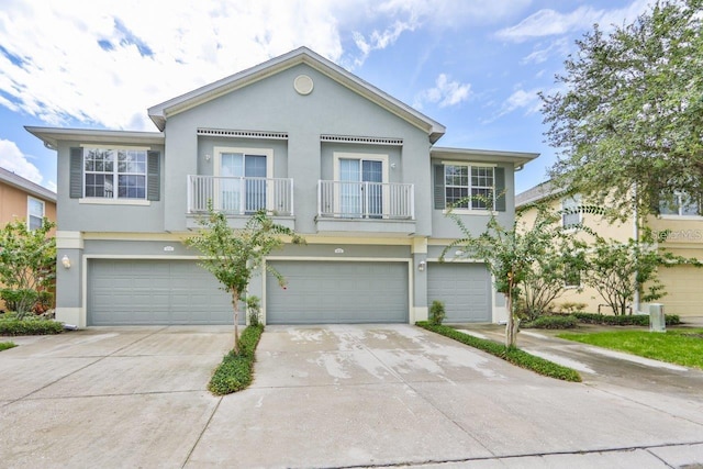 6734 Breezy Palm Dr, Riverview, FL 33578 - view of front of house with stucco siding, an attached garage, and a balcony