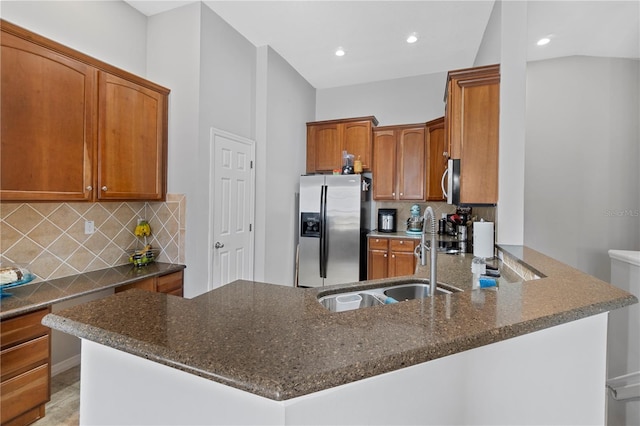 6734 Breezy Palm Dr, Riverview, FL 33578 - kitchen with appliances with stainless steel finishes, dark stone counters, tasteful backsplash, brown cabinetry, and recessed lighting