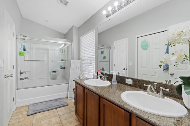 6734 Breezy Palm Dr, Riverview, FL 33578 - full bathroom featuring double vanity, vaulted ceiling, shower / bath combination with glass door, and tile patterned flooring