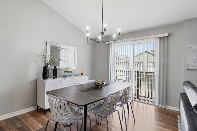 6734 Breezy Palm Dr, Riverview, FL 33578 - dining space featuring a chandelier, wood finished floors, and vaulted ceiling
