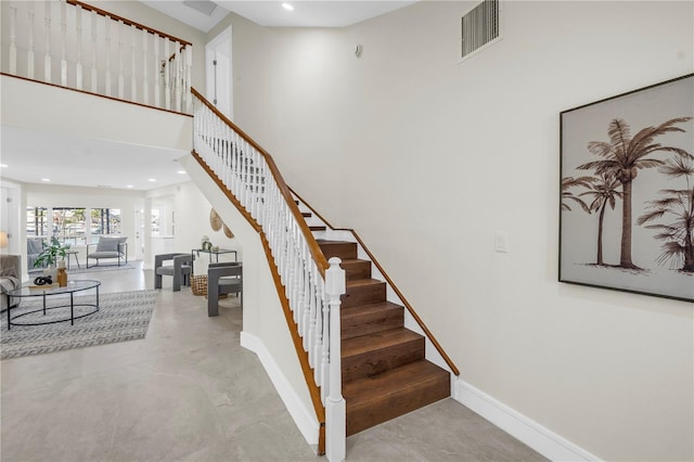 17601 Sterling Ter, Redington Shores, FL 33708 - stairs featuring recessed lighting and a high ceiling