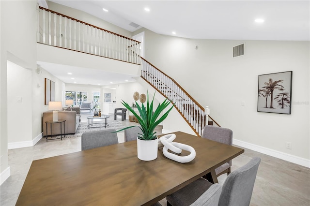 17601 Sterling Ter, Redington Shores, FL 33708 - dining space with recessed lighting, stairway, and a towering ceiling