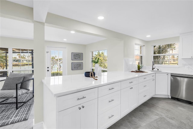 17601 Sterling Ter, Redington Shores, FL 33708 - kitchen featuring stainless steel dishwasher, a peninsula, white cabinets, and recessed lighting