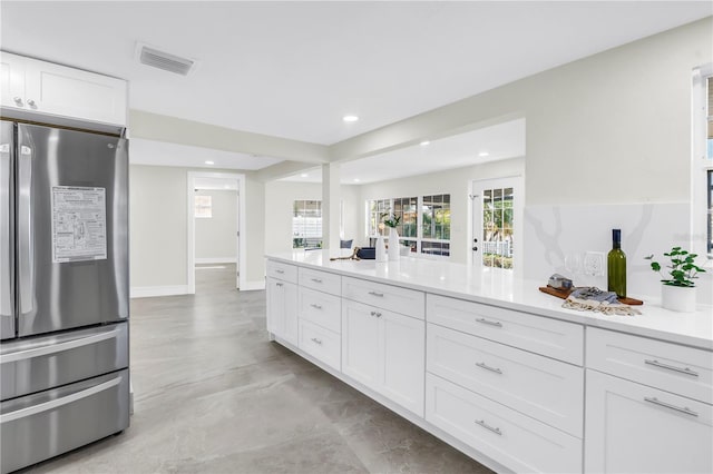 17601 Sterling Ter, Redington Shores, FL 33708 - kitchen with freestanding refrigerator, white cabinetry, recessed lighting, light countertops, and finished concrete floors