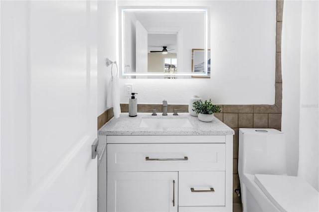 17601 Sterling Ter, Redington Shores, FL 33708 - bathroom with vanity, tile walls, and ceiling fan