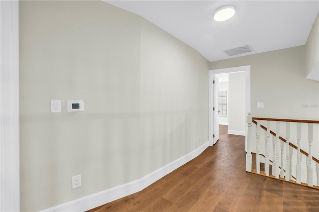 17601 Sterling Ter, Redington Shores, FL 33708 - hallway featuring wood finished floors, an upstairs landing, and vaulted ceiling