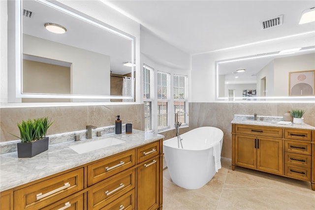 17601 Sterling Ter, Redington Shores, FL 33708 - bathroom featuring tile walls, vanity, and a freestanding tub