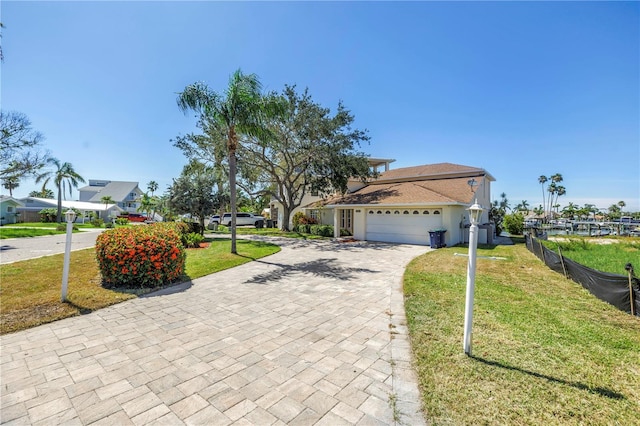 17601 Sterling Ter, Redington Shores, FL 33708 - view of front of house featuring an attached garage and decorative driveway