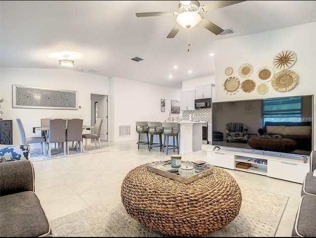 4282 Salt Springs Ln, Lakeland, FL 33811 - living room featuring a ceiling fan, vaulted ceiling, and light tile patterned floors
