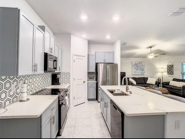 4282 Salt Springs Ln, Lakeland, FL 33811 - kitchen with black microwave, electric range oven, gray cabinets, dishwasher, and a ceiling fan