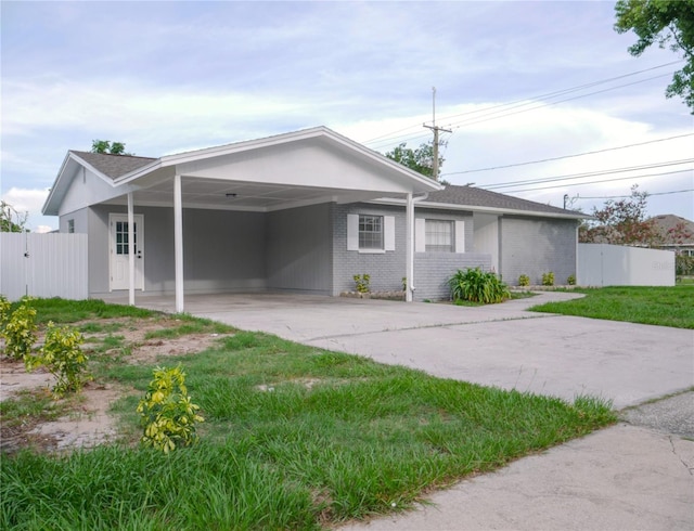 1302 Highview Rd, Brandon, FL 33510 - back of property featuring a carport, driveway, and brick siding
