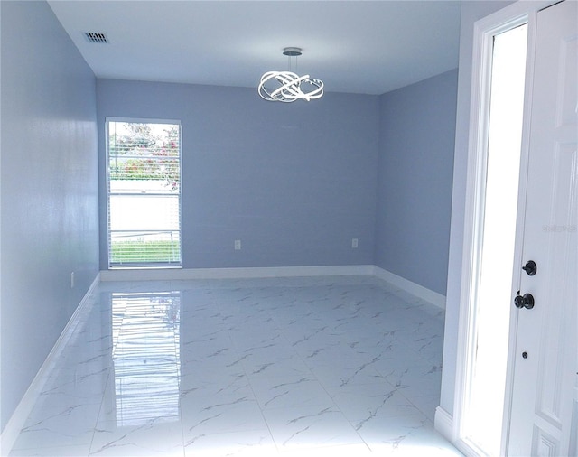 1302 Highview Rd, Brandon, FL 33510 - spare room featuring marble look tiles and a chandelier