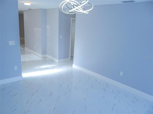 1302 Highview Rd, Brandon, FL 33510 - unfurnished room featuring marble look tiles and a chandelier