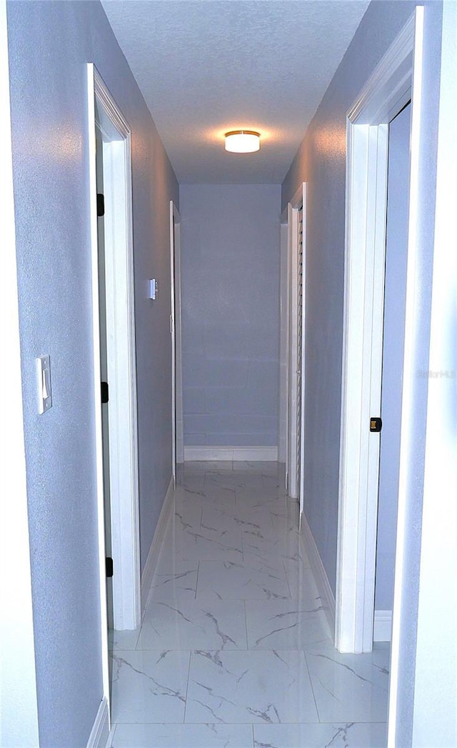 1302 Highview Rd, Brandon, FL 33510 - hallway with light marble finish floors and a textured ceiling
