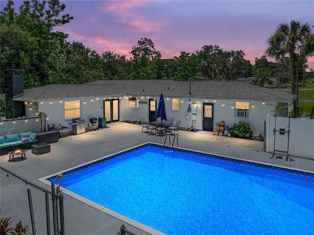 2937 Eagles Nest Rd, Fruitland Park, FL 34731 - pool at dusk with an outdoor living space, a gate, a patio, and grilling area