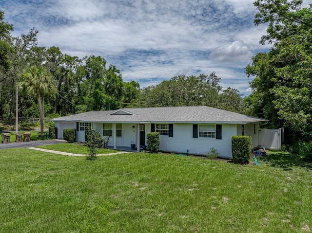 2937 Eagles Nest Rd, Fruitland Park, FL 34731 - ranch-style home with an attached garage, driveway, and view of scattered trees
