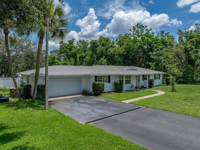 2937 Eagles Nest Rd, Fruitland Park, FL 34731 - ranch-style house with driveway, a garage, and a front lawn