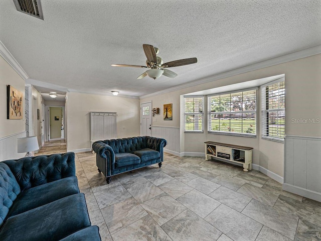 2937 Eagles Nest Rd, Fruitland Park, FL 34731 - living room with crown molding, wainscoting, and a ceiling fan