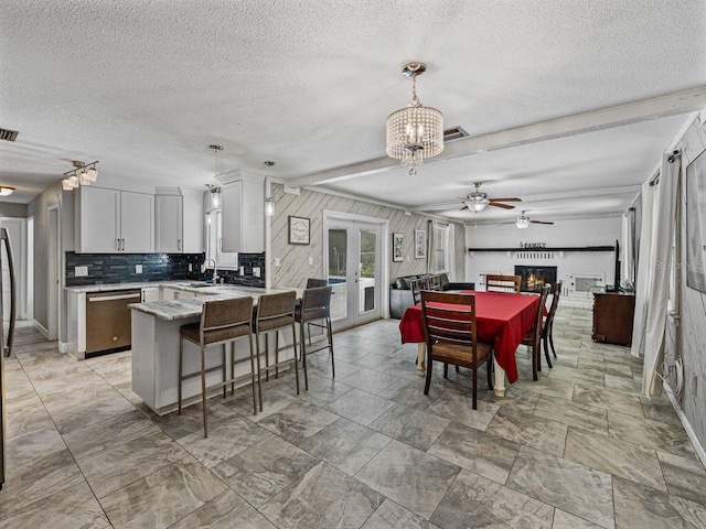 2937 Eagles Nest Rd, Fruitland Park, FL 34731 - dining room featuring french doors, a textured ceiling, a chandelier, and a ceiling fan