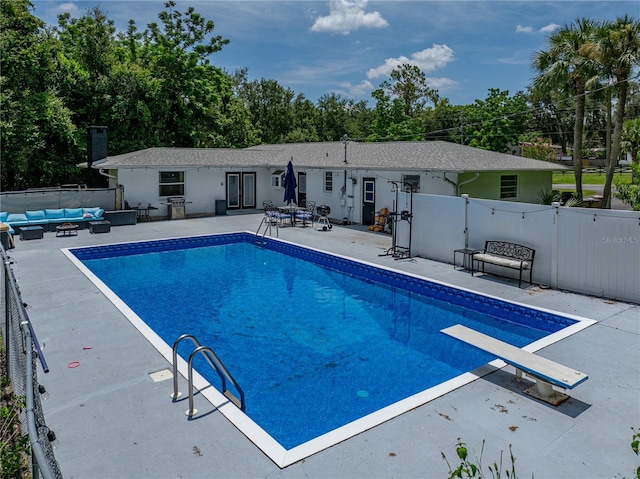 2937 Eagles Nest Rd, Fruitland Park, FL 34731 - view of swimming pool featuring outdoor lounge area, a gate, a diving board, a patio, and french doors