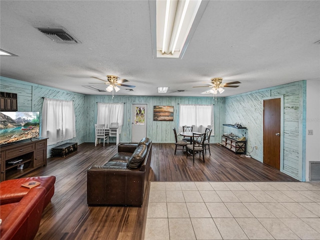 2937 Eagles Nest Rd, Fruitland Park, FL 34731 - living room with a ceiling fan, wood finished floors, and a textured ceiling