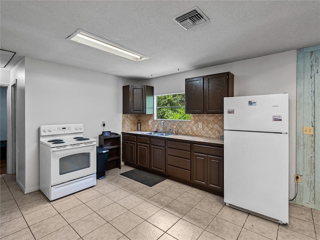 2937 Eagles Nest Rd, Fruitland Park, FL 34731 - kitchen with white appliances, dark brown cabinets, light countertops, backsplash, and light tile patterned floors