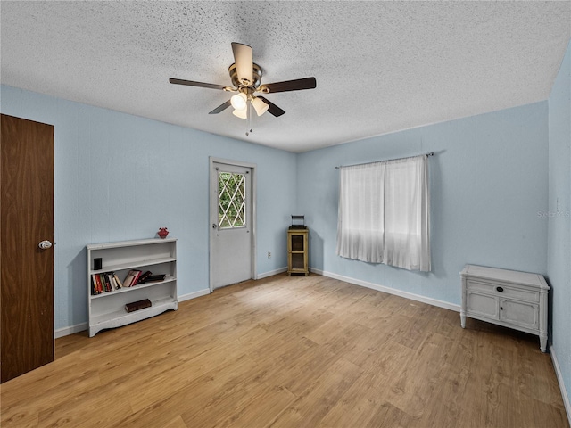 2937 Eagles Nest Rd, Fruitland Park, FL 34731 - unfurnished living room with a textured ceiling, ceiling fan, and wood finished floors