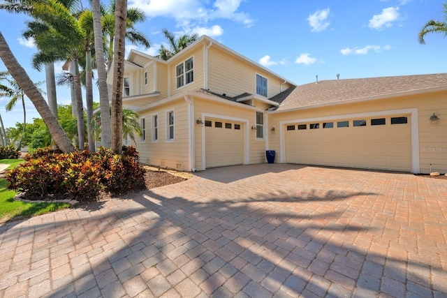 703 Islebay Dr, Apollo Beach, FL 33572 - traditional home with decorative driveway and a garage