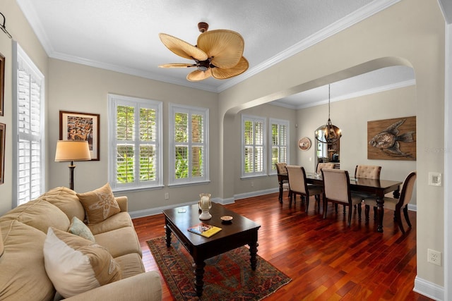703 Islebay Dr, Apollo Beach, FL 33572 - living room with dark wood-style flooring, a chandelier, arched walkways, and ornamental molding