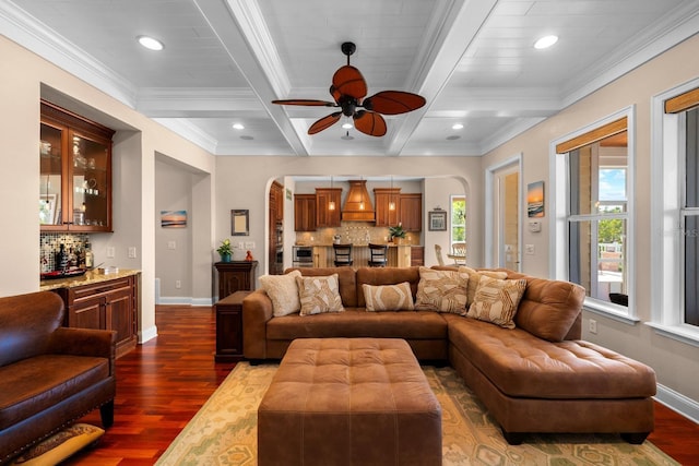 703 Islebay Dr, Apollo Beach, FL 33572 - living room featuring a dry bar, arched walkways, coffered ceiling, dark wood-style floors, and ornamental molding