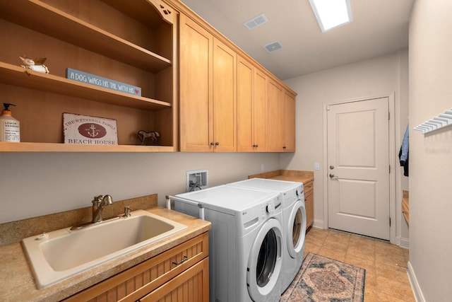 703 Islebay Dr, Apollo Beach, FL 33572 - laundry room with cabinet space, independent washer and dryer, and light tile patterned floors