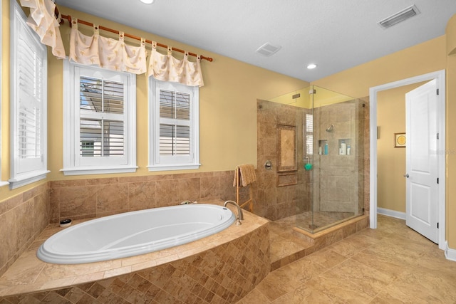 703 Islebay Dr, Apollo Beach, FL 33572 - full bath featuring a bath, a stall shower, healthy amount of natural light, tile patterned flooring, and recessed lighting