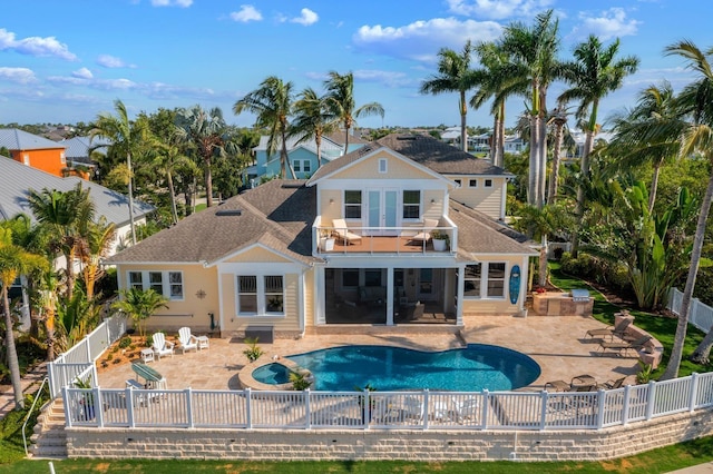 703 Islebay Dr, Apollo Beach, FL 33572 - rear view of house featuring a balcony, a fenced backyard, a patio, and a shingled roof