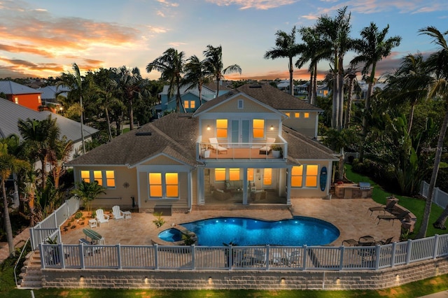703 Islebay Dr, Apollo Beach, FL 33572 - back of property with a balcony, a fenced backyard, a patio area, a pool with connected hot tub, and roof with shingles