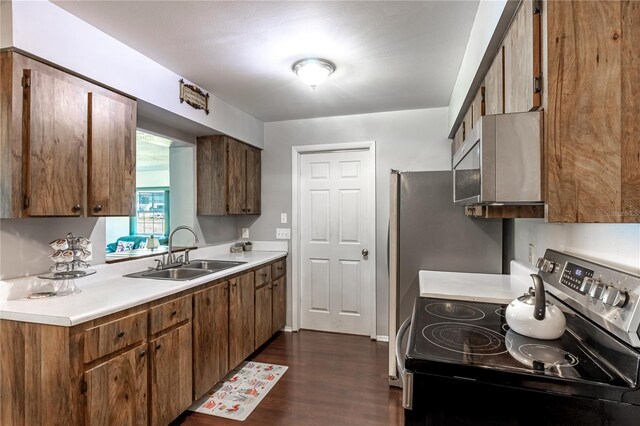 2719 N 91 Mine Rd, Bartow, FL 33830 - kitchen with appliances with stainless steel finishes, dark wood finished floors, light countertops, and brown cabinetry