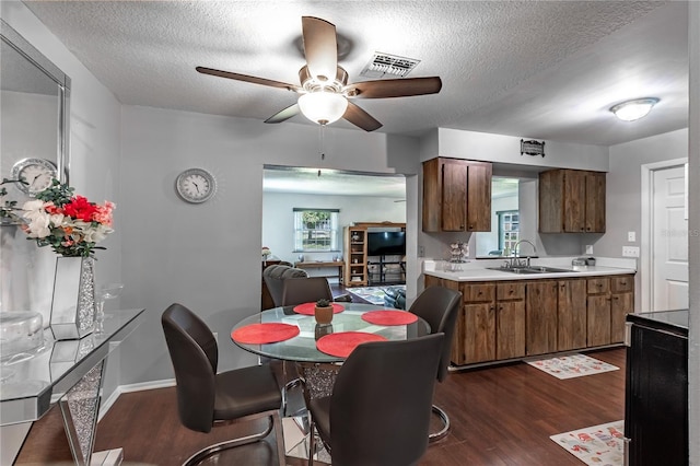2719 N 91 Mine Rd, Bartow, FL 33830 - dining room with dark wood-style flooring, a ceiling fan, and a textured ceiling