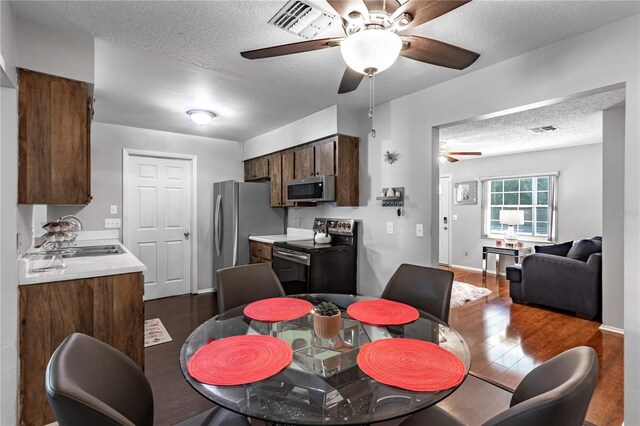 2719 N 91 Mine Rd, Bartow, FL 33830 - dining space with a ceiling fan, a textured ceiling, and dark wood-type flooring
