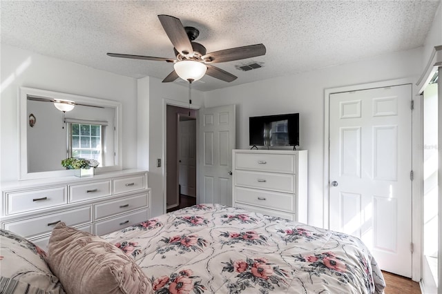 2719 N 91 Mine Rd, Bartow, FL 33830 - bedroom with a textured ceiling, a ceiling fan, and wood finished floors