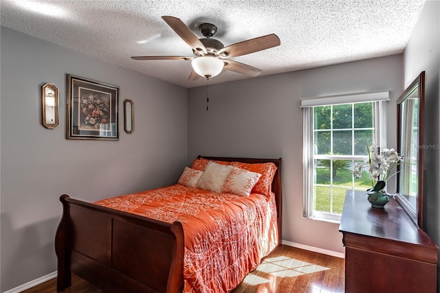 2719 N 91 Mine Rd, Bartow, FL 33830 - bedroom with wood finished floors, multiple windows, a textured ceiling, and a ceiling fan