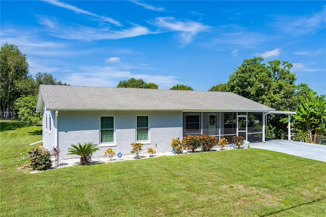 2719 N 91 Mine Rd, Bartow, FL 33830 - ranch-style house featuring concrete driveway, a carport, brick siding, a sunroom, and a front yard