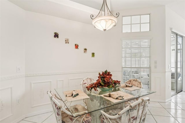 8704 Cypress Lakes Blvd, New Port Richey, FL 34653 - dining area with light tile patterned flooring and a wainscoted wall