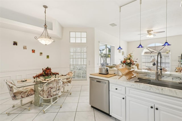 8704 Cypress Lakes Blvd, New Port Richey, FL 34653 - kitchen featuring stainless steel dishwasher, healthy amount of natural light, ceiling fan, and white cabinets