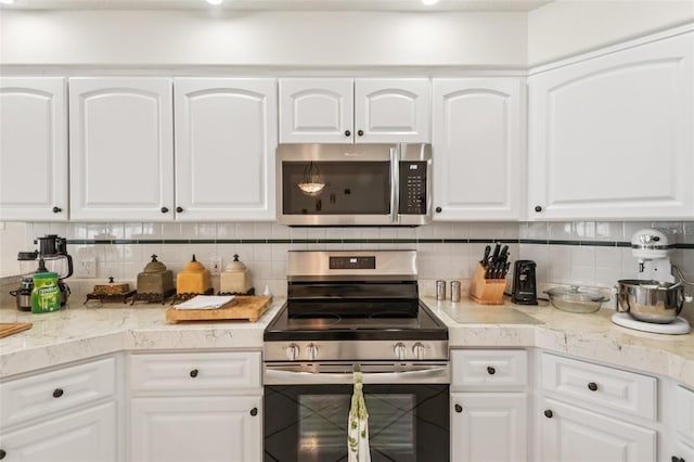 8704 Cypress Lakes Blvd, New Port Richey, FL 34653 - kitchen with appliances with stainless steel finishes and white cabinets