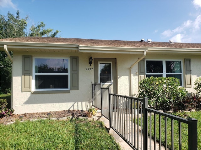 2227 Grenadier Dr Unit 140, Sun City Center, FL 33573 - view of front facade with stucco siding