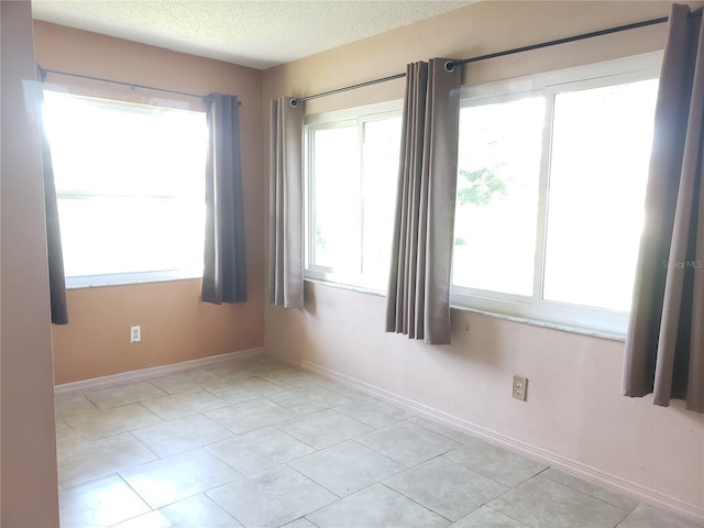 2227 Grenadier Dr Unit 140, Sun City Center, FL 33573 - unfurnished room with a textured ceiling and light tile patterned floors